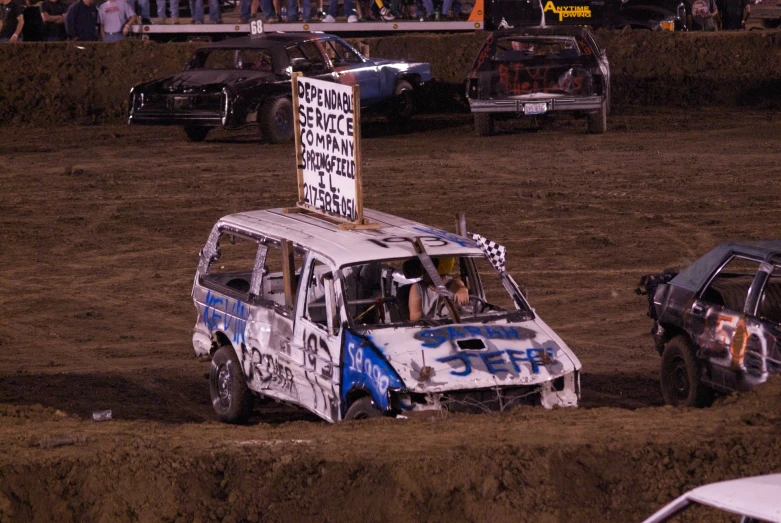 a minivan and cars stuck in a field