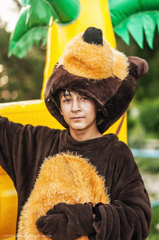 a boy wearing a costume of a bear and banana