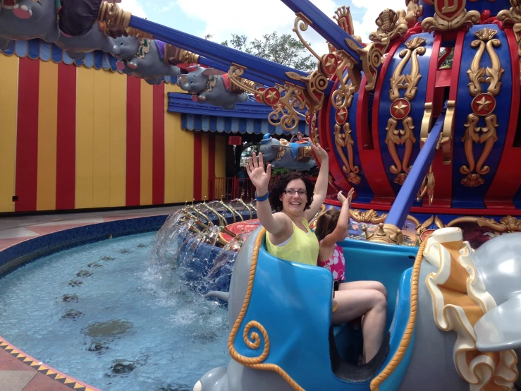 an attractive woman riding in a colorful attraction