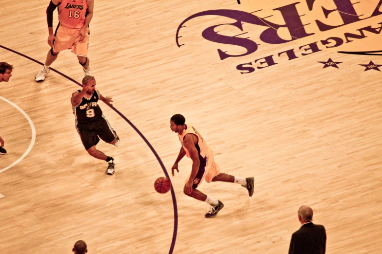 a group of men playing a game of basketball