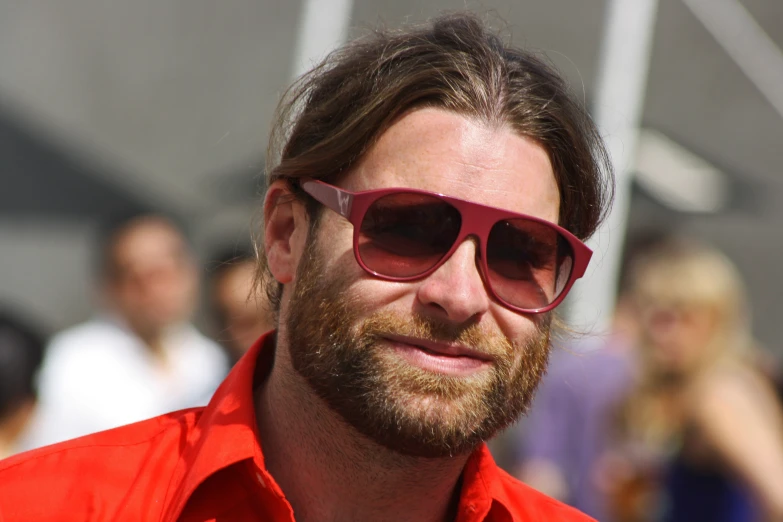 a close up of a man wearing red sunglasses