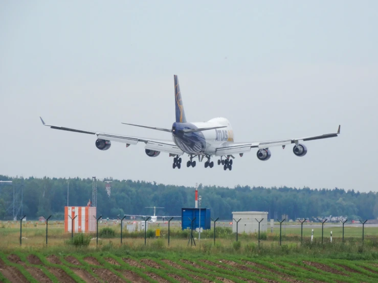 an airplane about to land and fly over the field