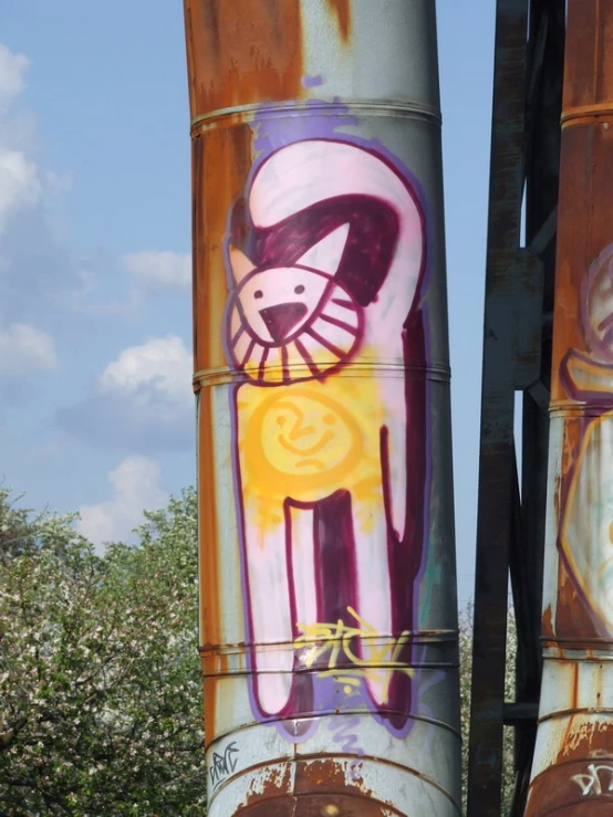 two old steel pipes covered in art and graffiti