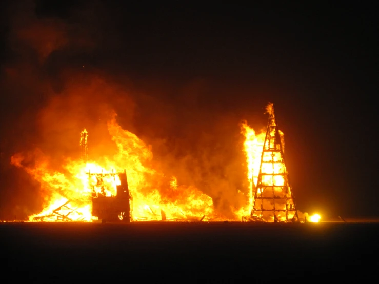 the fire is in the sky behind a house