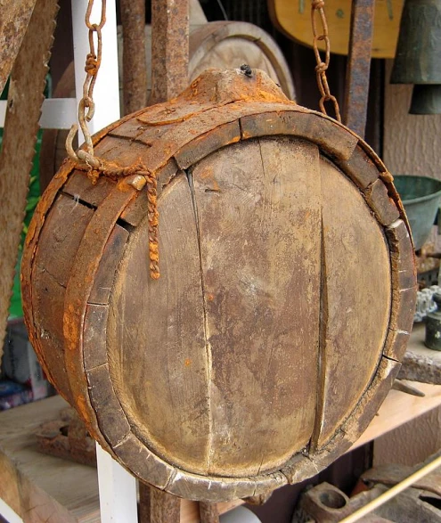 an old wooden bucket being held with chains