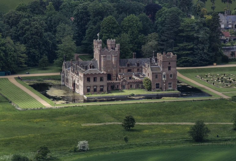 an old palace surrounded by lush green fields