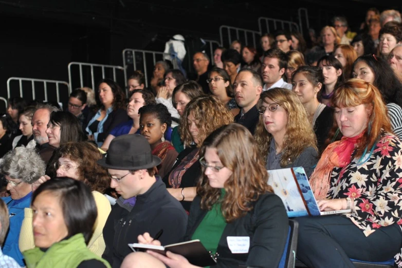 people watching an auditorium with a speaker