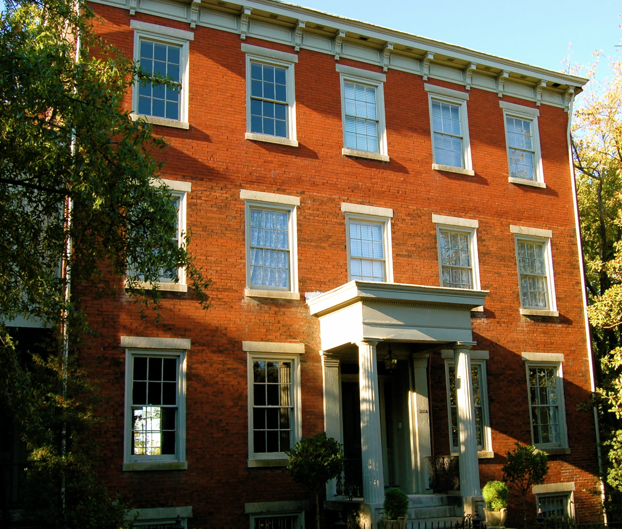 the front of a house with large brick windows