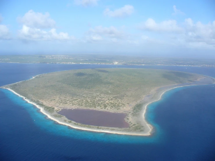 an island is surrounded by bright blue waters