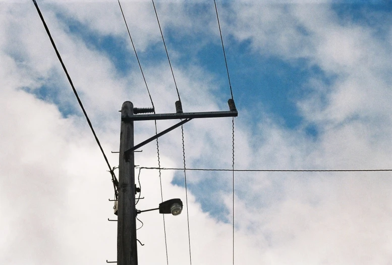 an intersection with a street light and telephone wires