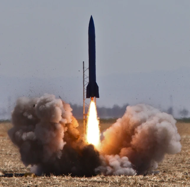 a rocket is launching with its back end in the air