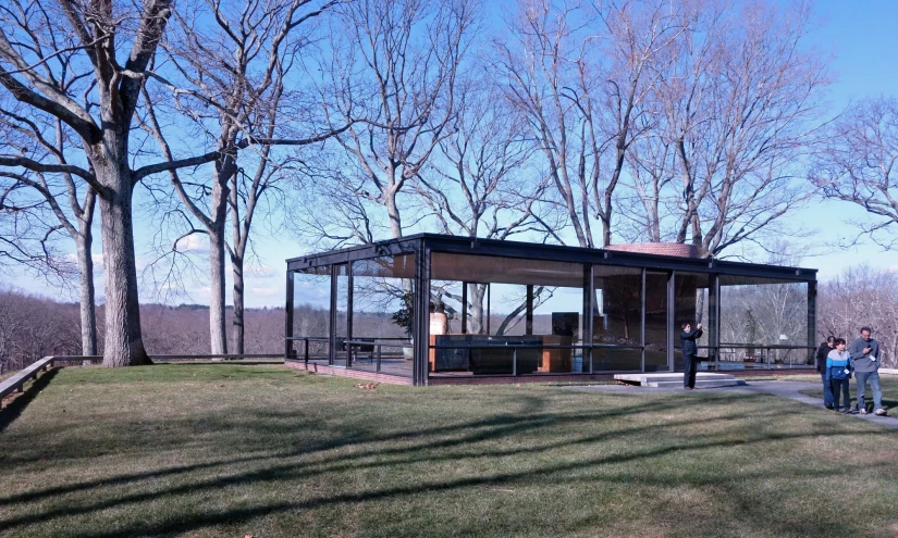 some people standing in front of a shelter at a park