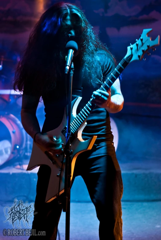 a black and orange guitar playing on stage