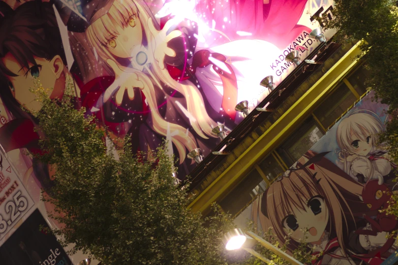 a group of anime posters on a wall in the night