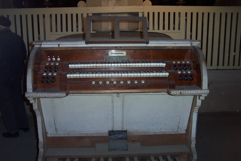 old organ with electronic keys on wooden paneled table