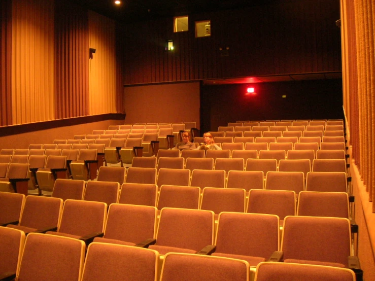an empty theater auditorium with a person taking a po