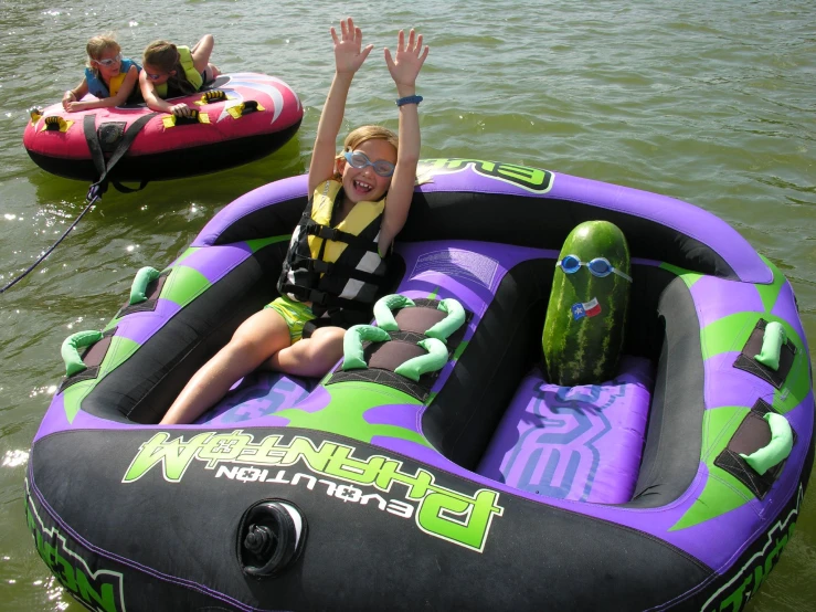 three people are rafting down a body of water