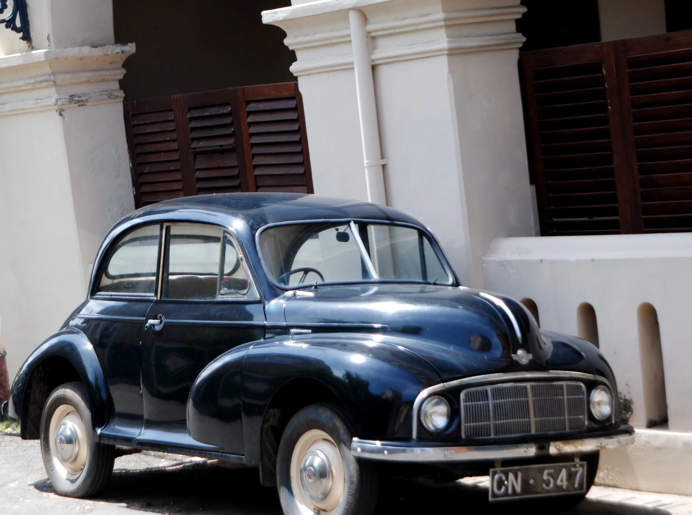 an old car sitting outside a building