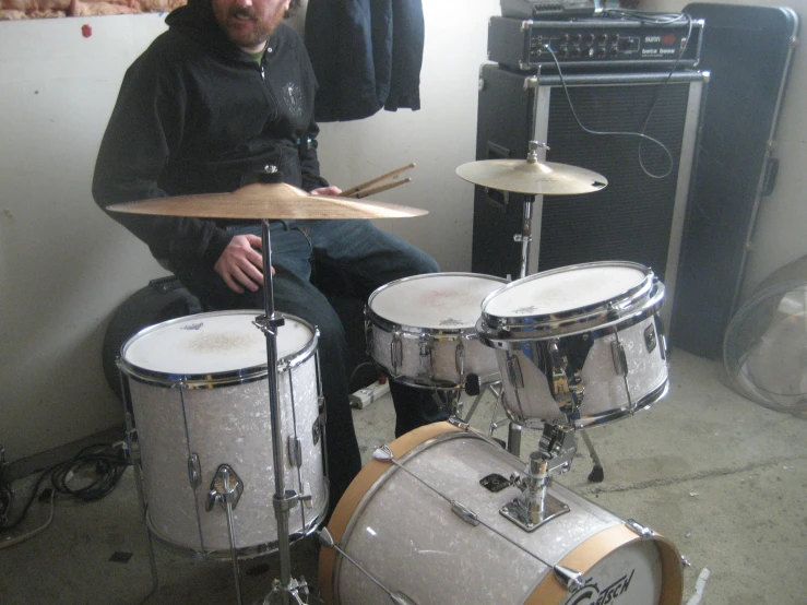 a man holding drums in his right hand