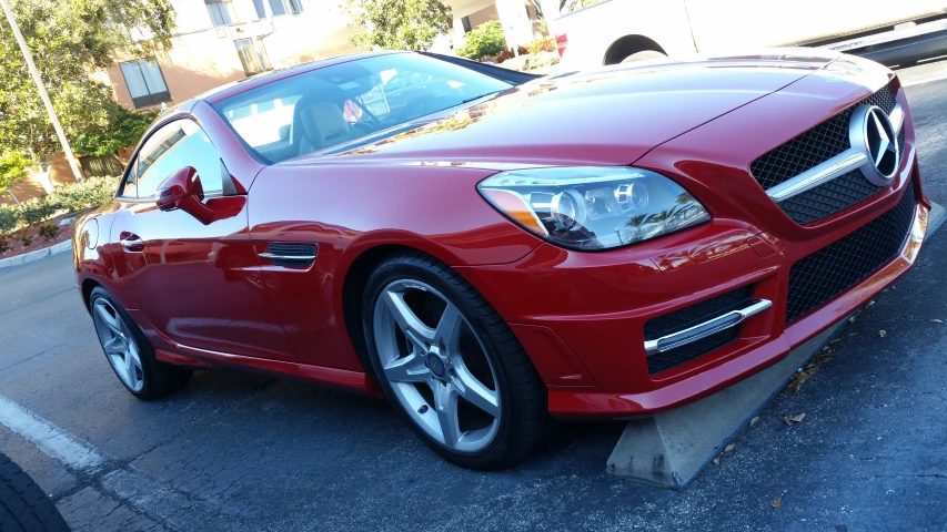 the red car is parked on the curb