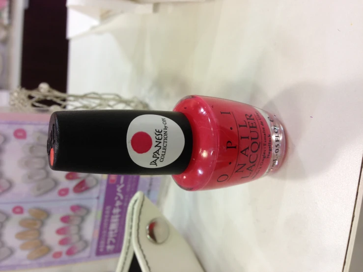 an opel nail polish in pink and black