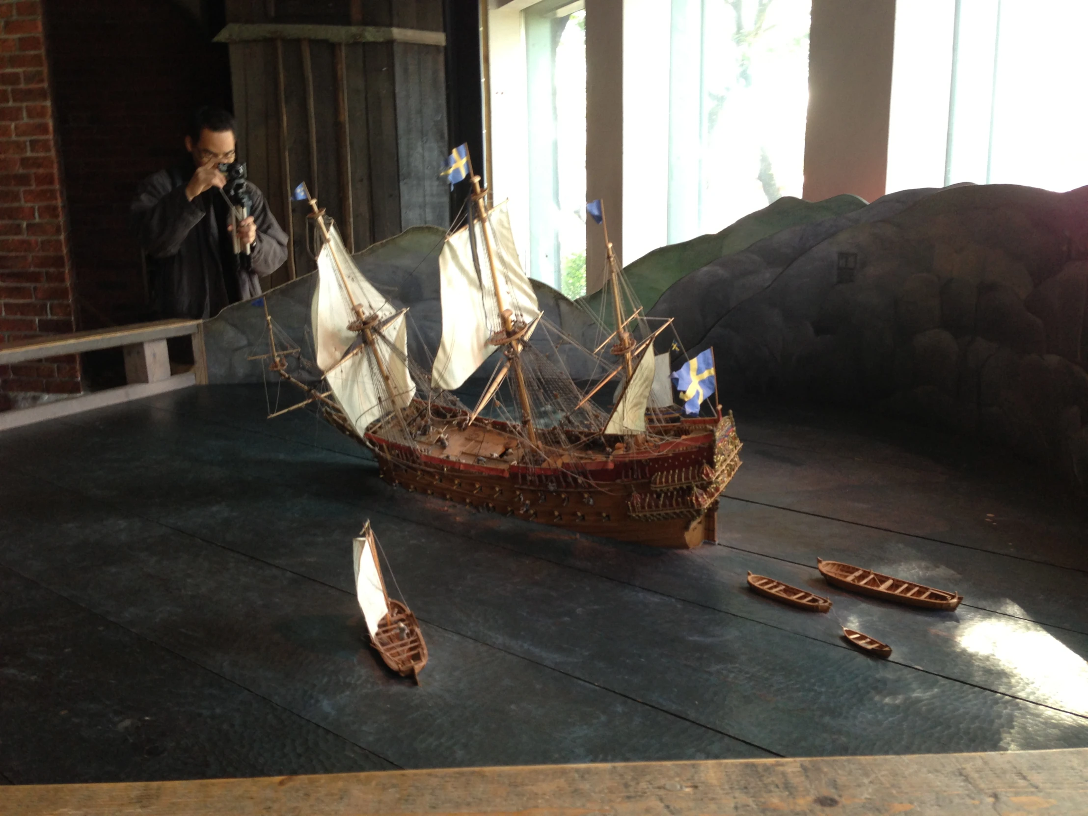 a model ship on display next to a mirror