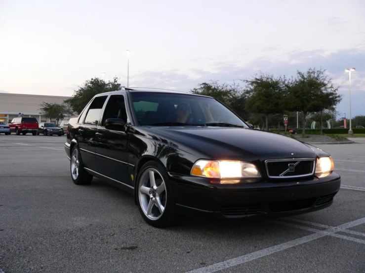 black volvo wagon is parked in an empty parking lot