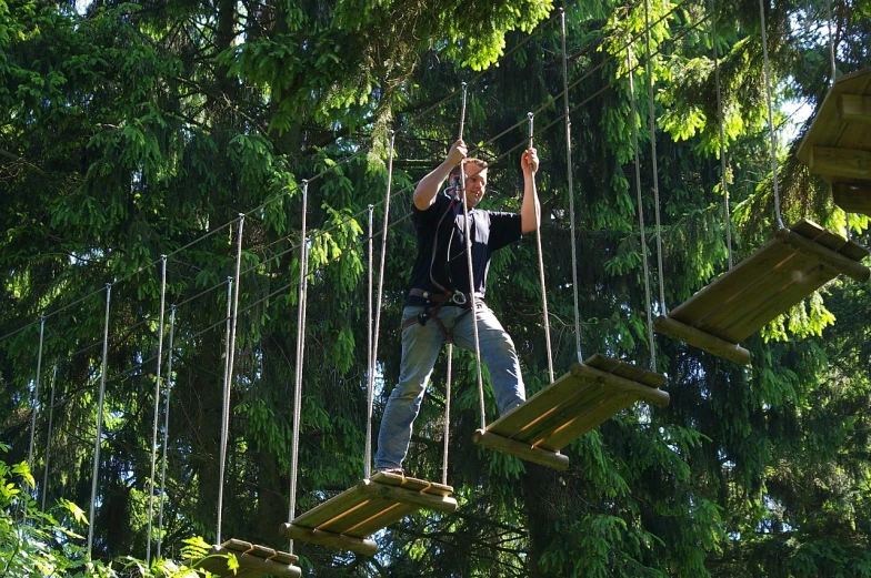 a man riding on a wooden obstacle course