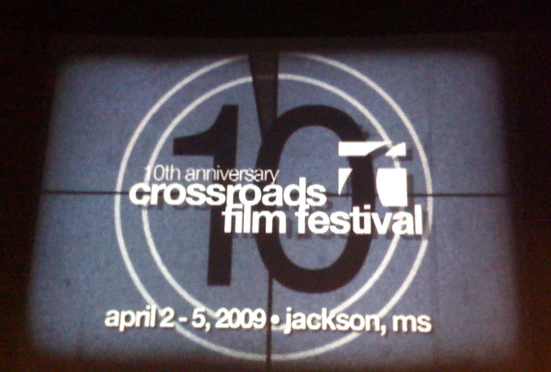 the 10th anniversary crossroads film festival logo projected onto a television screen