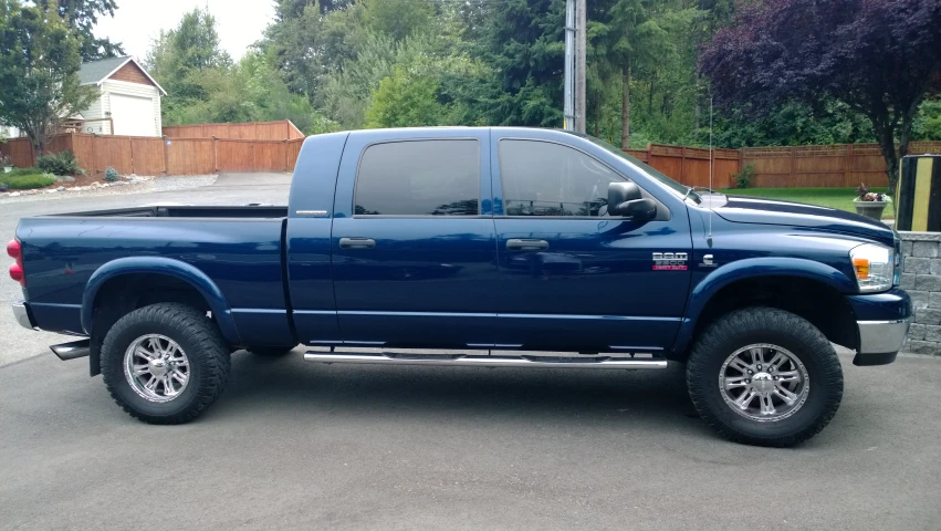 a blue truck is parked in a parking lot