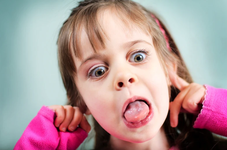 a girl with her tongue hanging out making a funny face