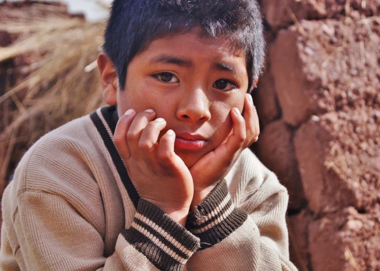 a child is smiling while wearing sweaters