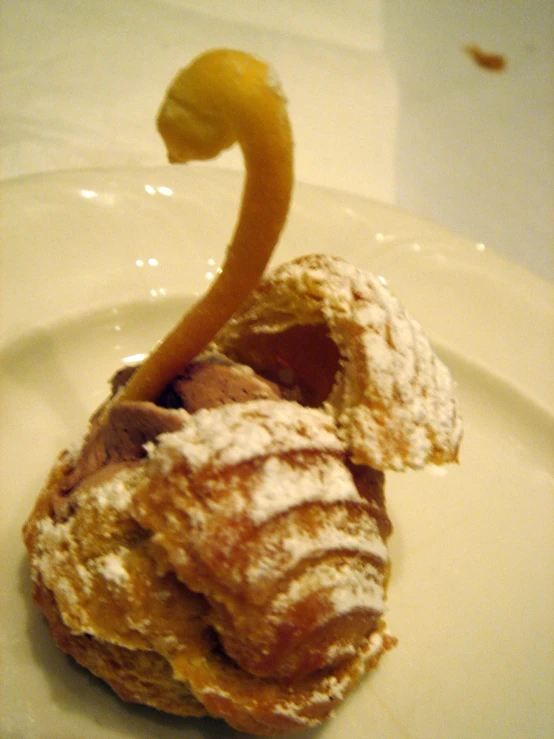 a very pretty nice looking doughnut on a big white plate