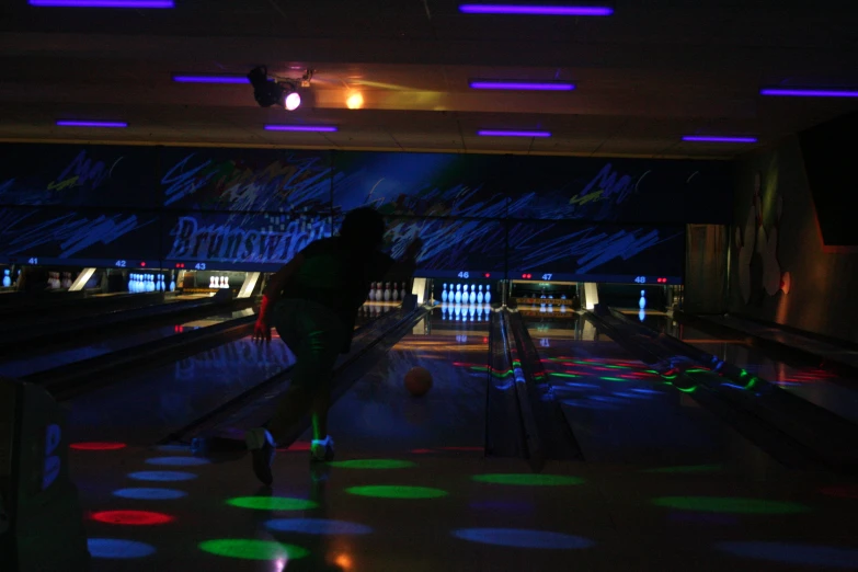 a bowling alley with lanes and colorful lights