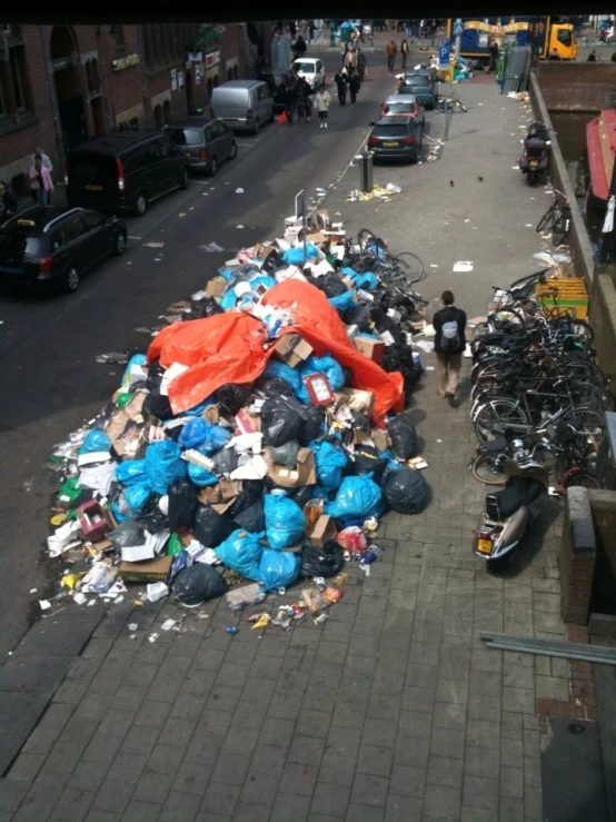 an umbrella is covering over trash near a street