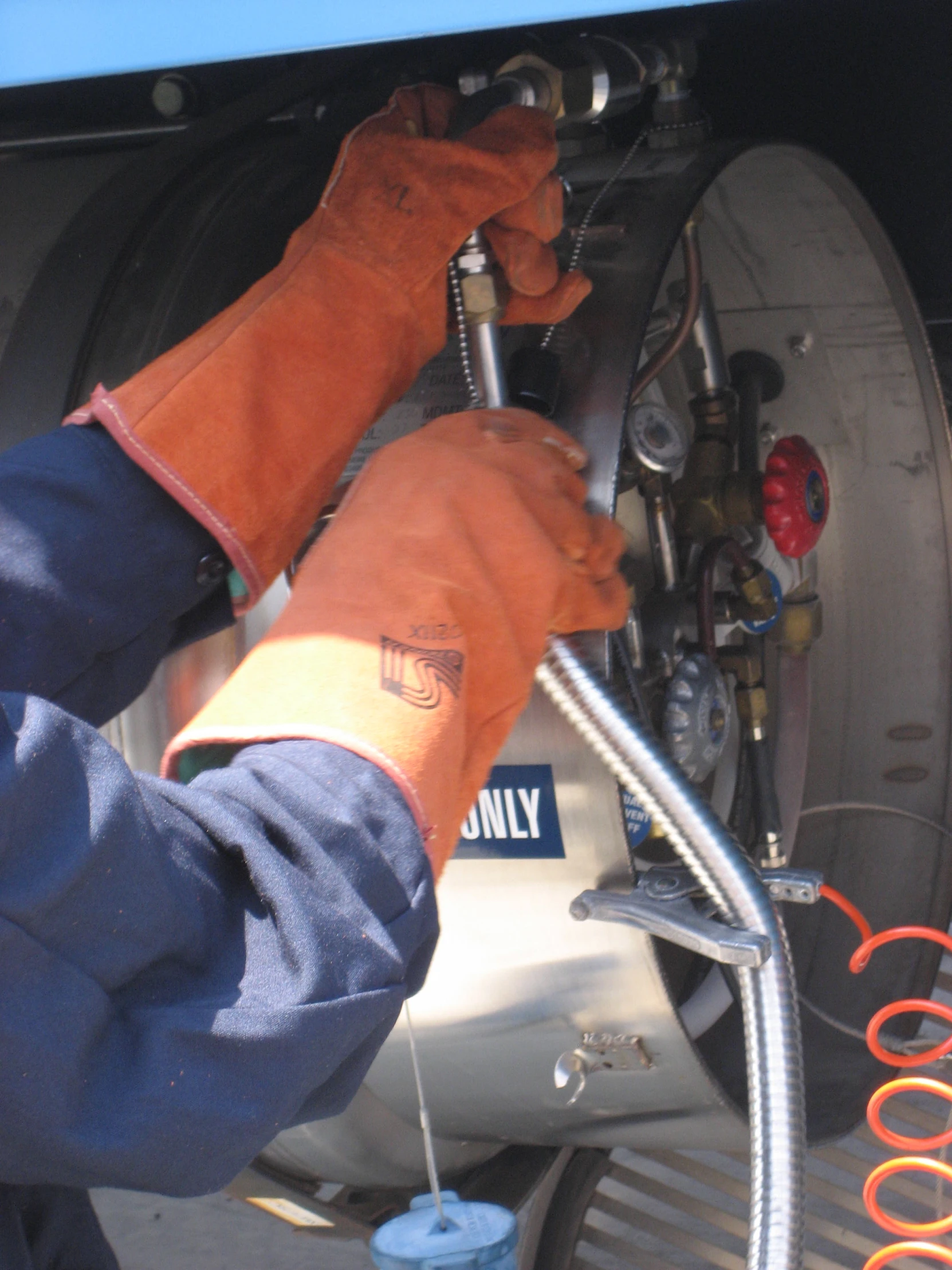 a worker working on the side of a parked car