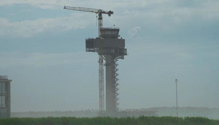 an industrial building is shown with a crane on top