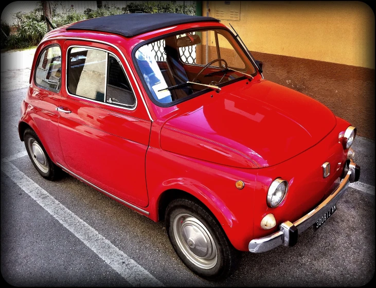 an old style red car in a parking lot