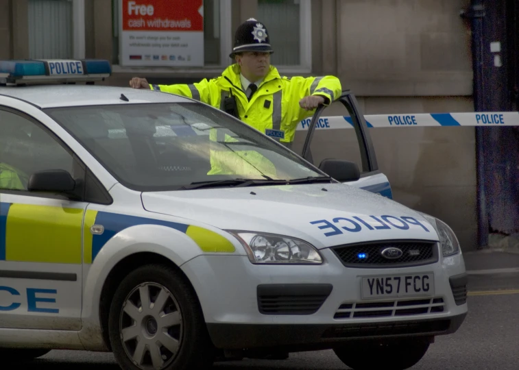 police officer standing in front of his car