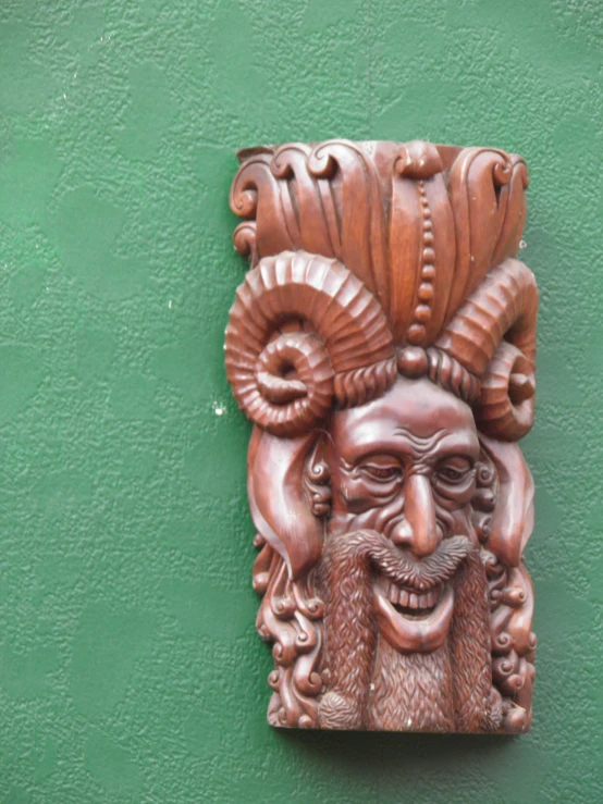 an ornamental carved stone gargoyle on the side of a building