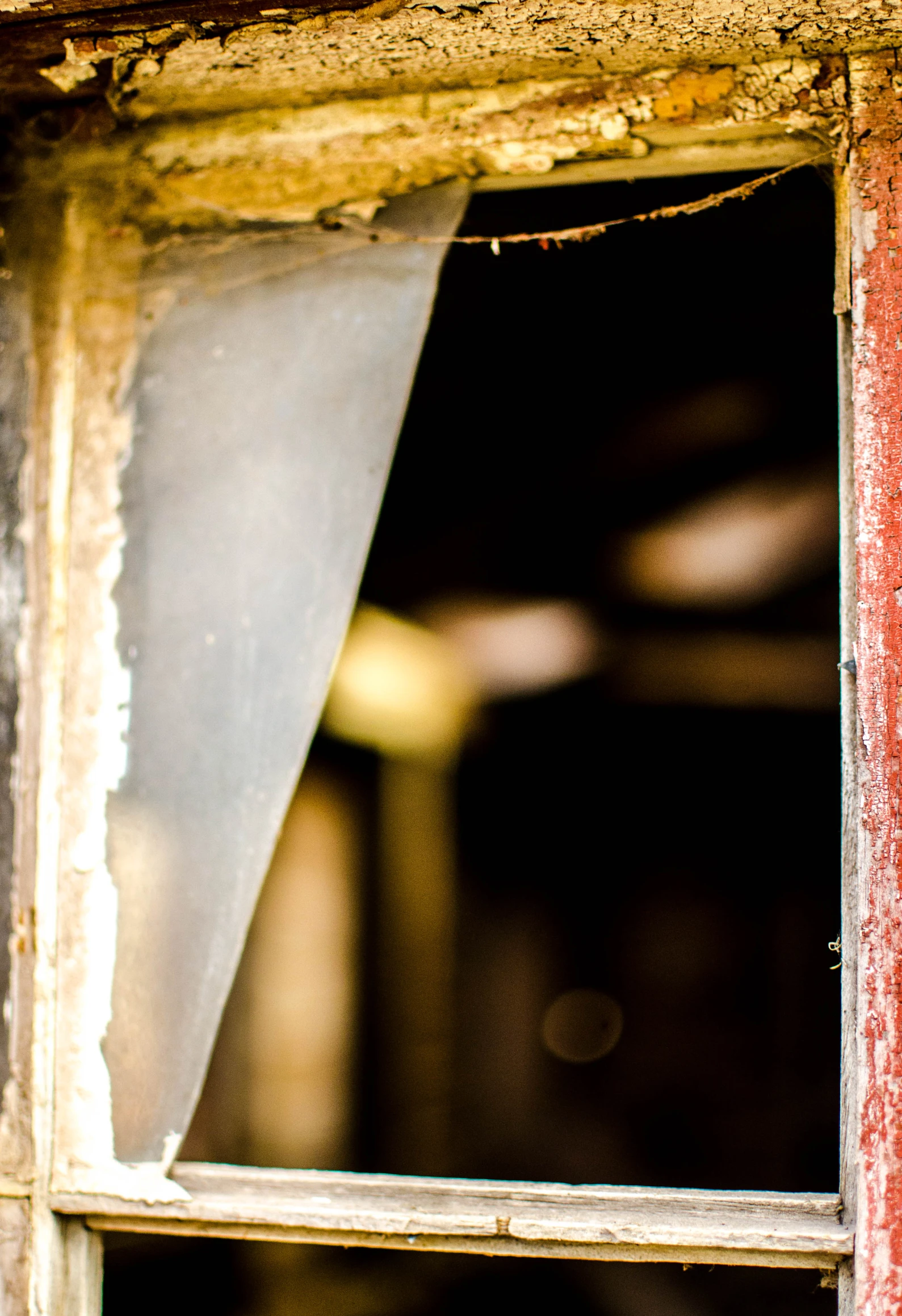 window with grungy window frames and a small screen