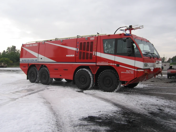 a large fire truck parked on the snow covered ground