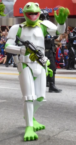a man dressed as a star wars storm trooper waves while carrying an action figure