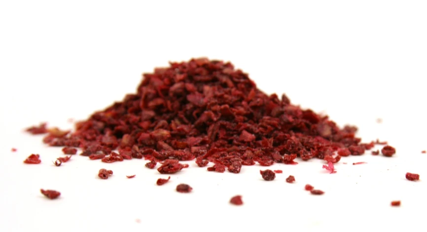 a pile of red mung oats against a white background