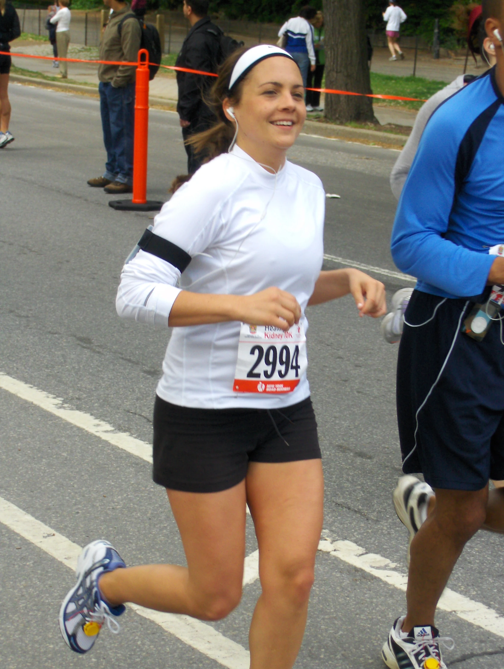 woman running through the streets of a marathon