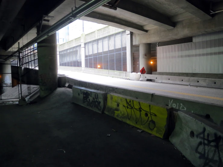 a po taken from inside a dark tunnel with graffiti on the side and below