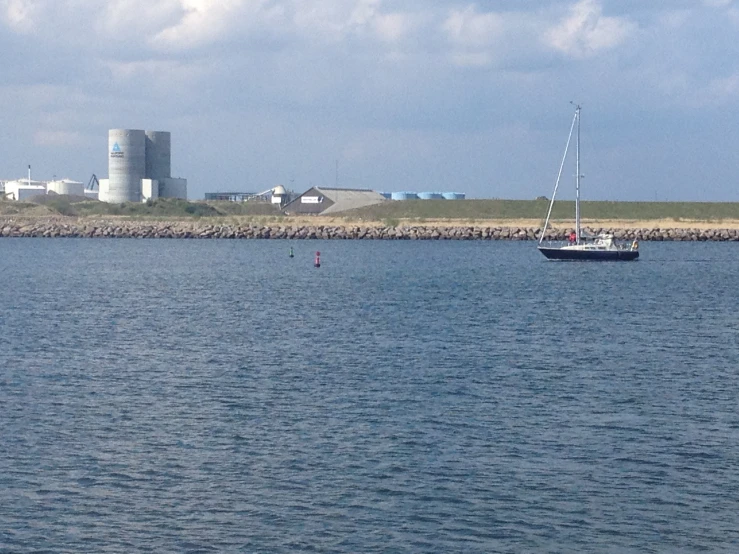 a boat in the water near a nuclear plant