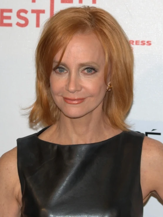 an older woman with blonde hair and a black leather dress at the festival