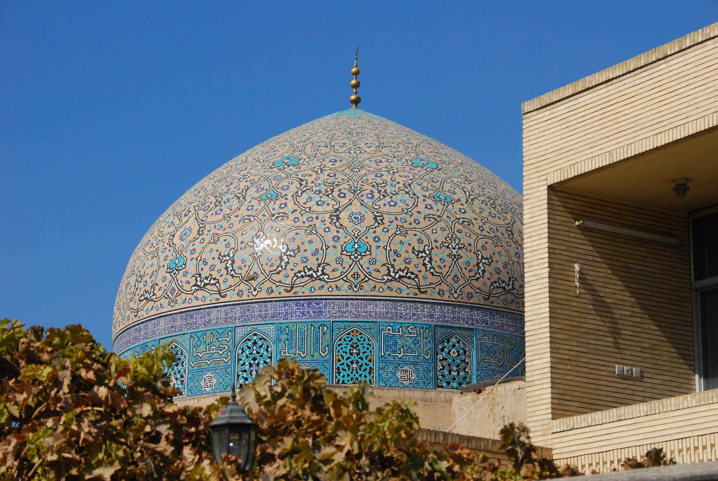 a blue and white mosque near some brown bricks