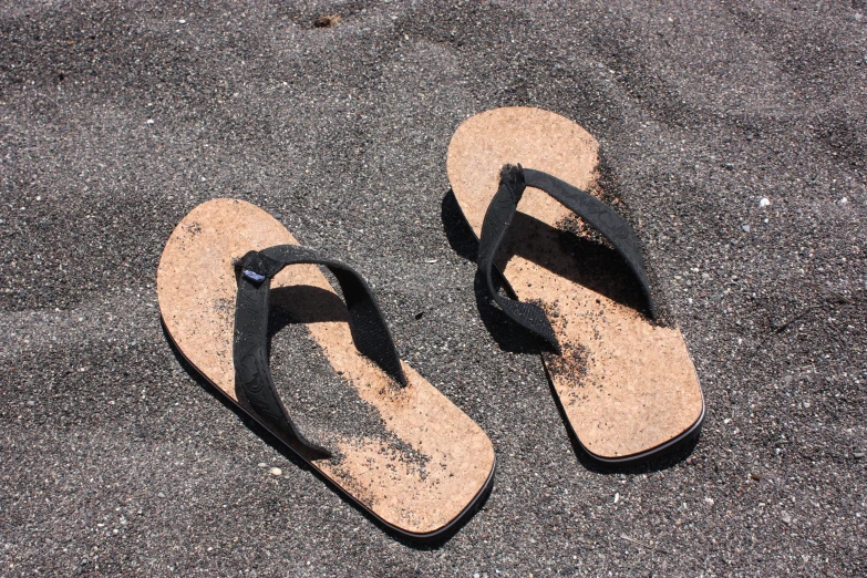 a pair of sandals laying on top of the ground